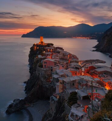 aerial view of village on mountain cliff during orange sunset